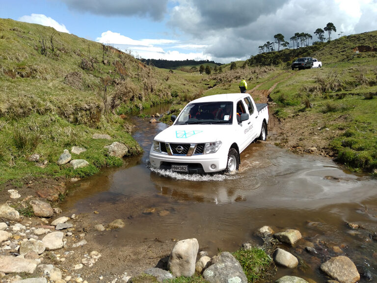 Learners driving through different terrain in a ute on a farm